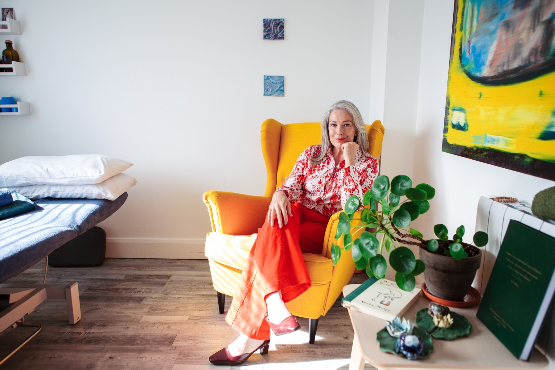 Ruth Molloy relaxed in her home office, seated in a yellow armchair